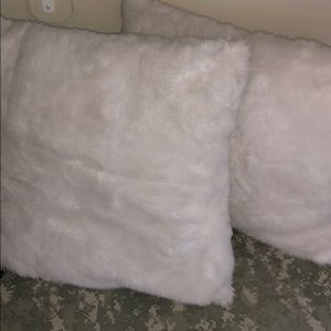 2 fluffy white throw pillows